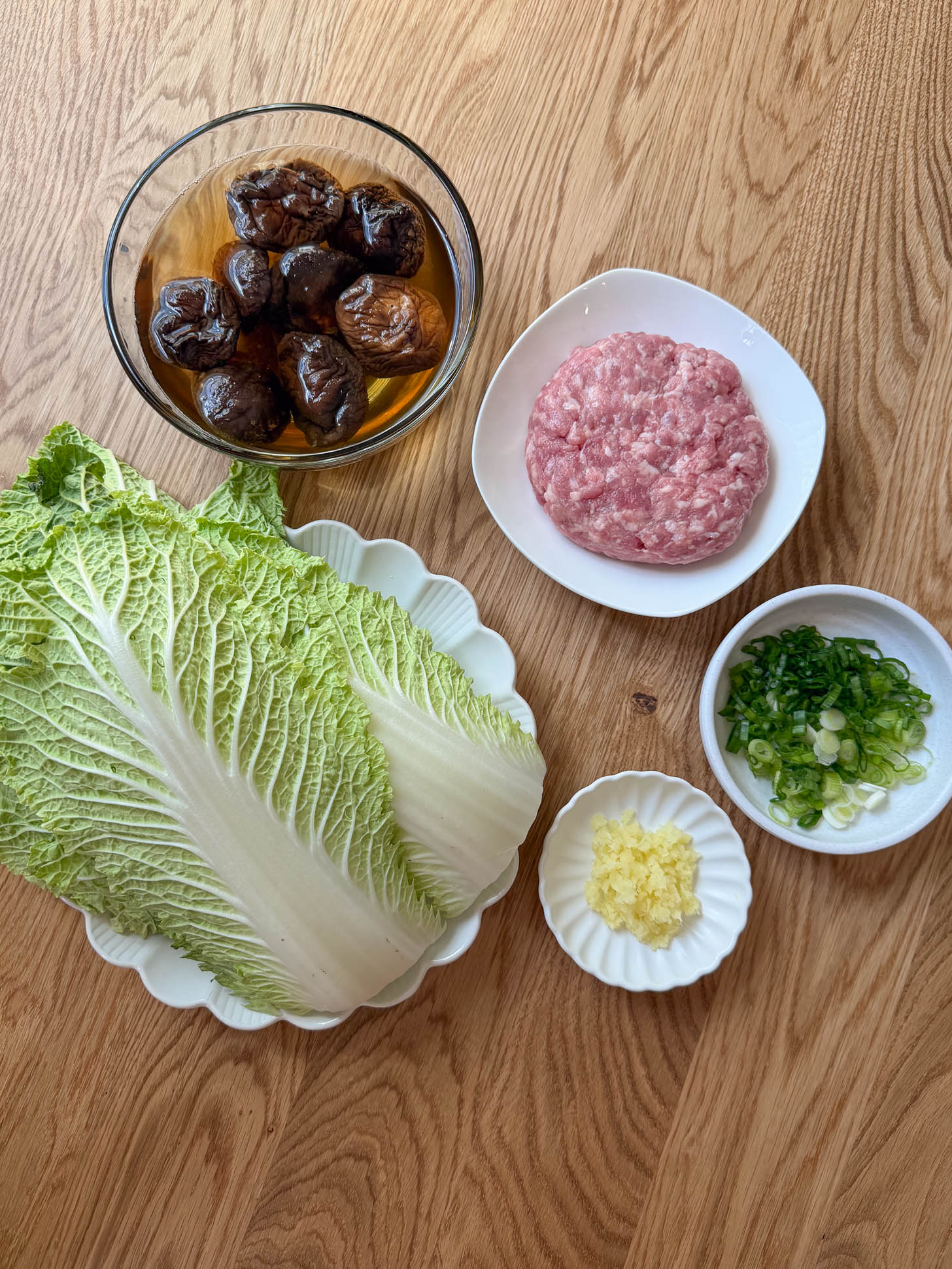 Napa cabbage, ground pork, dried shiitake mushrooms, ginger, and scallions for stuffed cabbage rolls