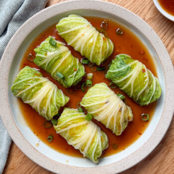 Chinese stuffed napa cabbage rolls with pork and shiitake mushroom filling in a savory sauce